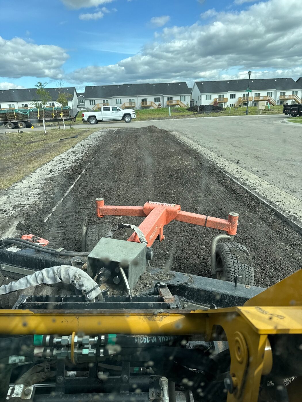 Perfect Turf preparing and grading soil with equipment before sod installation